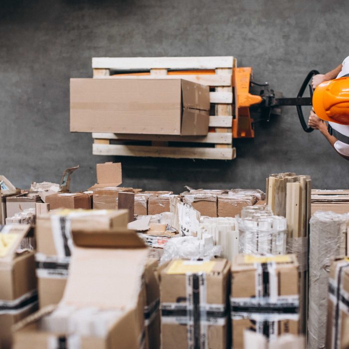 young-man-working-warehouse-with-boxes-optimized